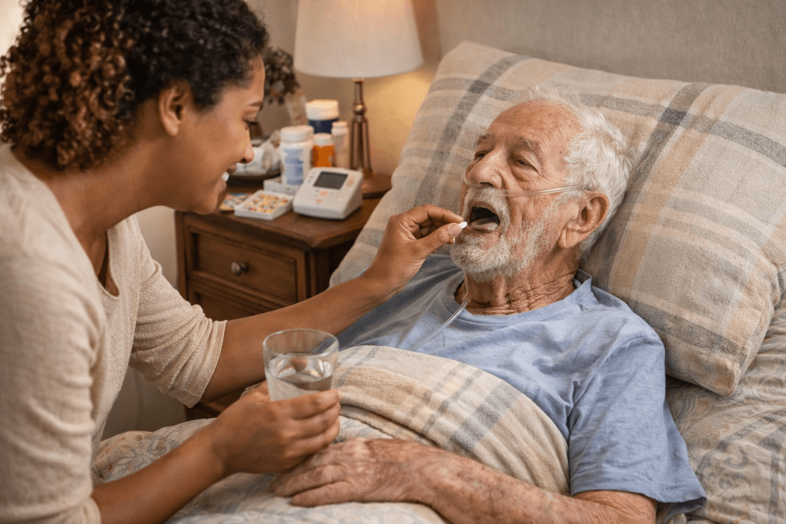 Caregiver assisting senior man with medication while he rests at home.